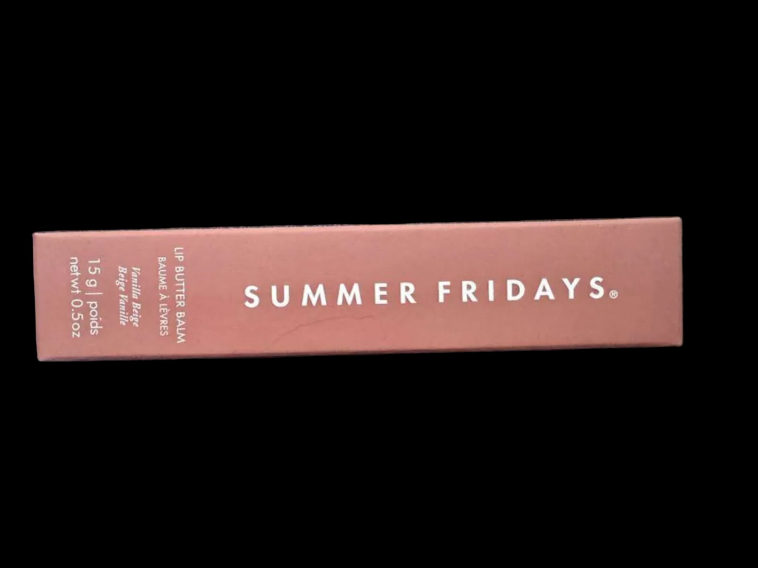 Pink lip balm packaging with 'Summer Fridays' branding on a dark background